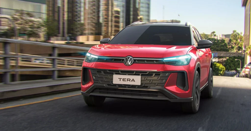 The 2025 VW Tera showcases its bold front fascia with LED headlights and a distinctive grille, finished in vibrant red.