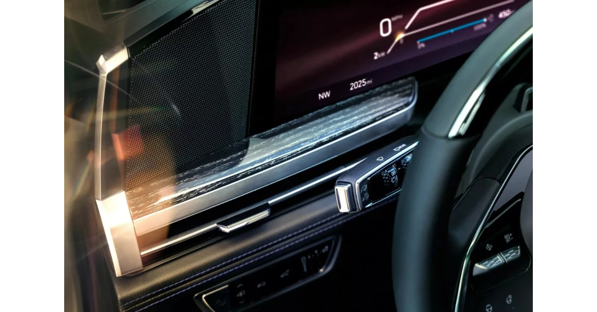 A close-up view of the Escalade IQL's digital display shows the crisp graphics and sophisticated interface. The system displays vehicle information, navigation, and range details, with the vehicle capable of traveling up to 460 miles on a single charge.