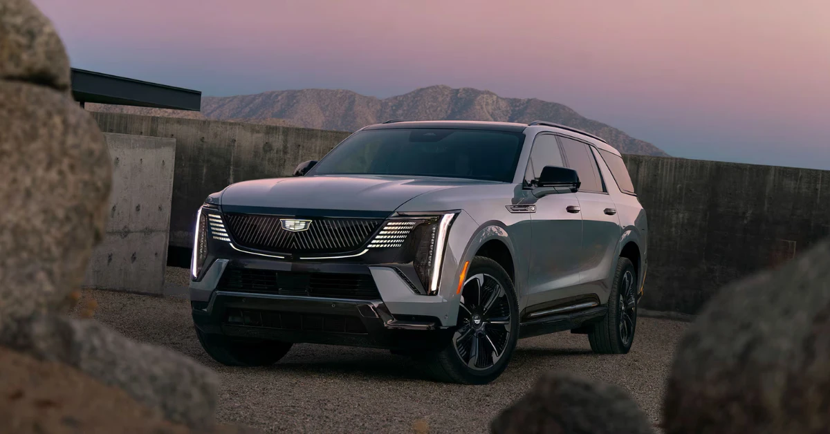 The 2026 Escalade IQL presents an imposing front view at dusk, with its distinctive LED lighting elements creating a dramatic visual signature. Powered by dual electric motors producing up to 750 horsepower, this luxury behemoth can accelerate to 60 mph in just 4.7 seconds.