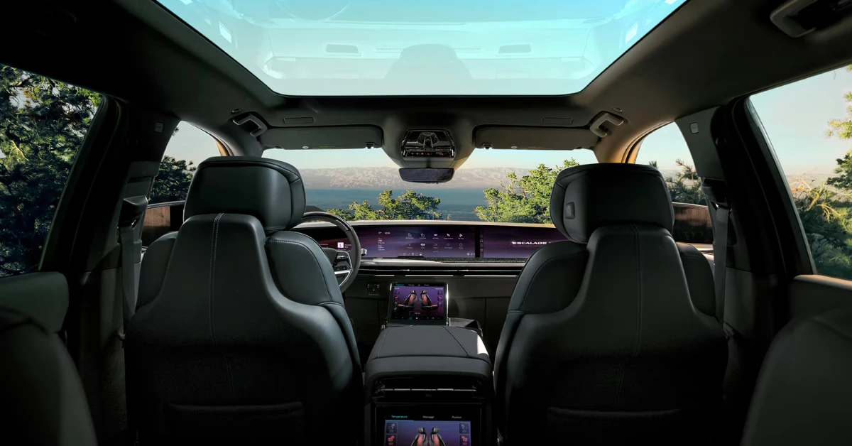 The interior of the Escalade IQL features a panoramic glass roof that floods the cabin with natural light. The view from the second row showcases the 55-inch digital display and spacious cabin that can accommodate up to seven passengers in supreme comfort.