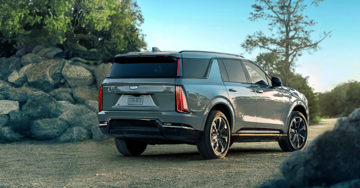 The rear quarter view of the Escalade IQL highlights its more upright back end with the unique triangular C-pillar and more vertical D-pillar, distinguishing it from the standard IQ model. The extended length provides more third-row space and cargo capacity.