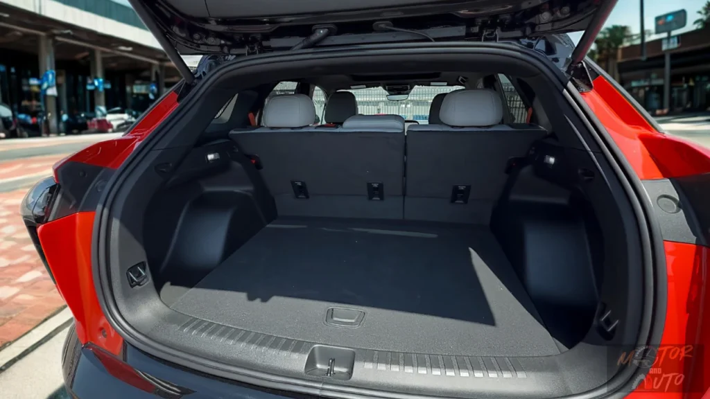 The 2025 Chevrolet Blazer EV offers a spacious and practical cargo area with 25.5 cubic feet of storage behind the second row, expanding to 59.1 cubic feet with seats folded, showcased in this red SS model.