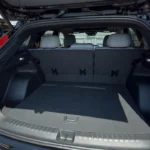 The 2025 Chevrolet Blazer EV offers a spacious and practical cargo area with 25.5 cubic feet of storage behind the second row, expanding to 59.1 cubic feet with seats folded, showcased in this red SS model.