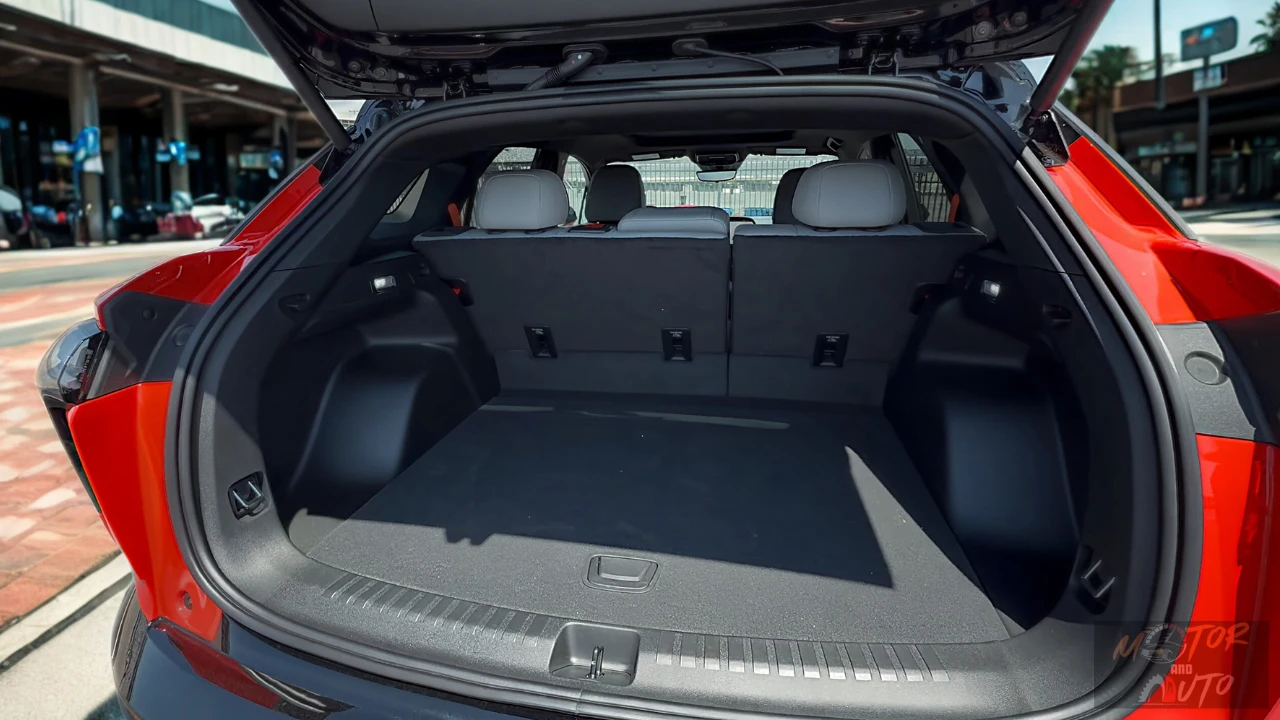 The 2025 Chevrolet Blazer EV offers a spacious and practical cargo area with 25.5 cubic feet of storage behind the second row, expanding to 59.1 cubic feet with seats folded, showcased in this red SS model.