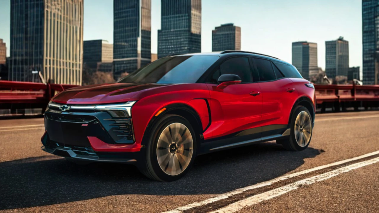 The 2025 Chevrolet Blazer EV SS in motion highlights its athletic stance, dramatic proportions, and aerodynamic design, with up to 21-inch wheels and a two-tone color treatment featuring a black roof and vibrant red body.