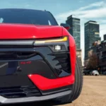 The 2025 Chevrolet Blazer EV RS features a distinctive front end with illuminated LED daytime running lights, SS badging, and an aggressive black fascia design that emphasizes the vehicle's performance-oriented character.