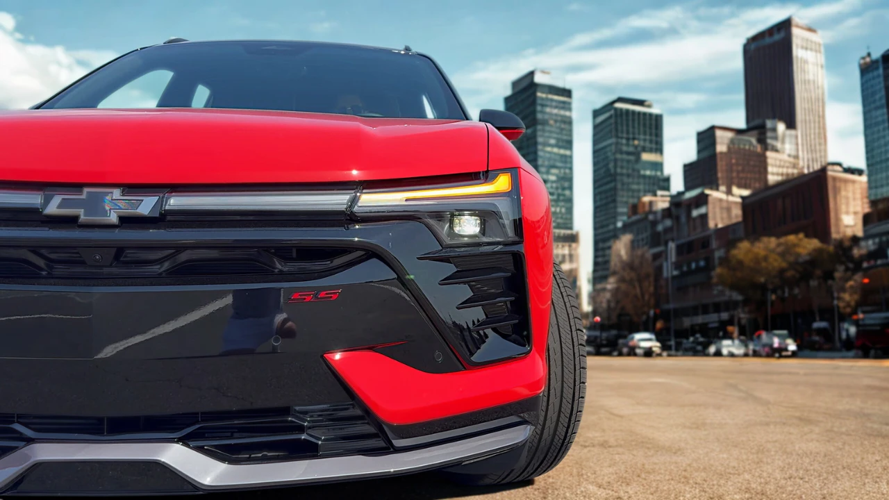 The 2025 Chevrolet Blazer EV RS features a distinctive front end with illuminated LED daytime running lights, SS badging, and an aggressive black fascia design that emphasizes the vehicle's performance-oriented character.
