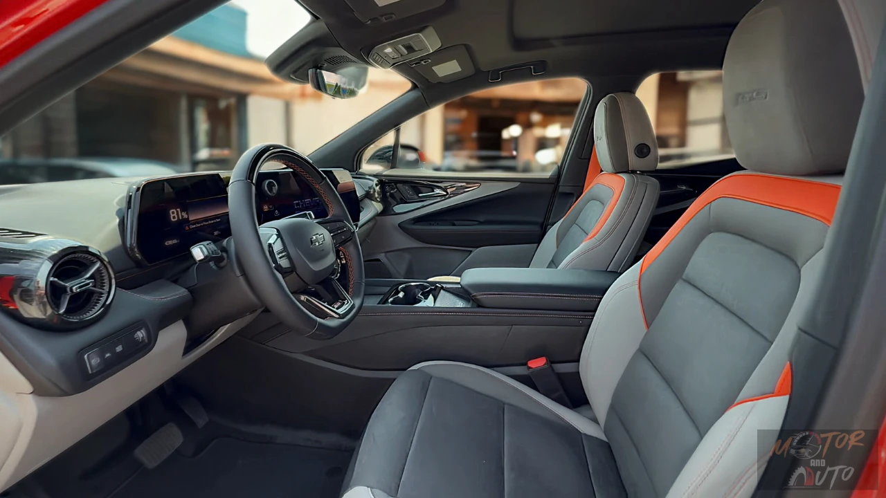 The 2025 Chevrolet Blazer EV SS interior features premium gray and orange-accented seats with a sporty cockpit design, large digital driver display, and a clean modern dashboard layout.