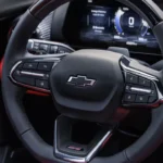The flat-bottom, leather-wrapped steering wheel in the 2025 Blazer EV SS features integrated controls, premium stitching, and the SS badge, highlighting its performance-oriented character.