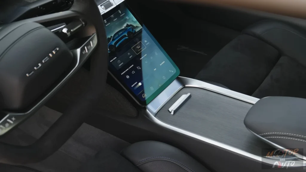 Angled view of the 2025 Lucid Air's center console touchscreen showing the vehicle settings menu with drive mode controls and a blue car graphic against a dark background.