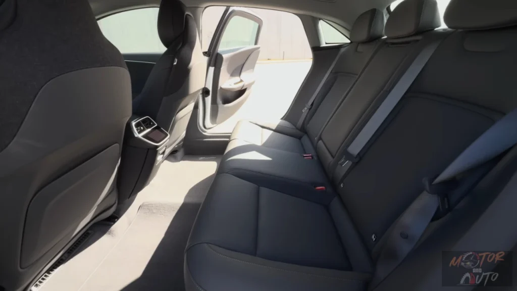The extraordinary rear passenger accommodation in the 2025 Lucid Air, which offers limousine-like legroom despite the vehicle's mid-size exterior dimensions. The rear seating area comfortably fits passengers well over six feet tall, even behind similarly tall front occupants.