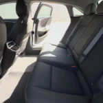 The extraordinary rear passenger accommodation in the 2025 Lucid Air, which offers limousine-like legroom despite the vehicle's mid-size exterior dimensions. The rear seating area comfortably fits passengers well over six feet tall, even behind similarly tall front occupants.