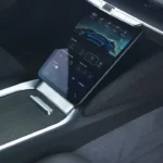The 2025 Lucid Air's innovative lower touchscreen display featuring the vehicle settings menu and drive mode controls. This screen can retract into the dashboard to reveal additional storage space, demonstrating Lucid's thoughtful interior design approach.
