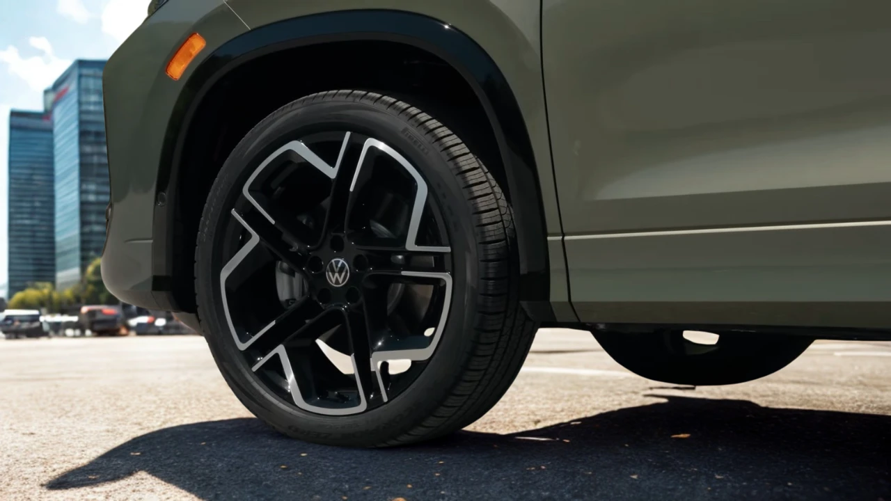 Close-up detail of 2025 Volkswagen Tiguan alloy wheel showing spoke design, Volkswagen center cap, and tire sidewall