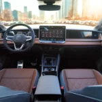 Full interior view of the 2025 Tiguan SEL R-Line showcasing the premium brown and black leather seats with quilted pattern, walnut wood trim, and sophisticated cabin design that rivals luxury vehicles.