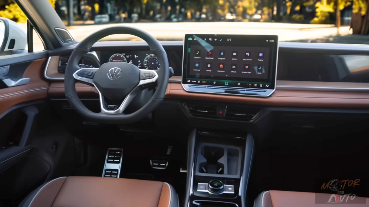 Interior view of 2025 Volkswagen Tiguan dashboard featuring large 15-inch touchscreen, wood trim, leather seats, and premium materials
