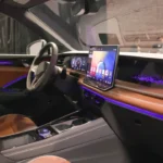 Night view of 2025 Volkswagen Tiguan interior featuring ambient lighting, wood trim, and premium materials with purple accent lighting