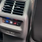 Rear climate control panel in 2025 Volkswagen Tiguan showing temperature display, heated seat controls, and air vents