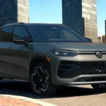Three-quarter front view of 2025 Volkswagen Tiguan in gray metallic showing side profile, alloy wheels, and modern SUV proportions