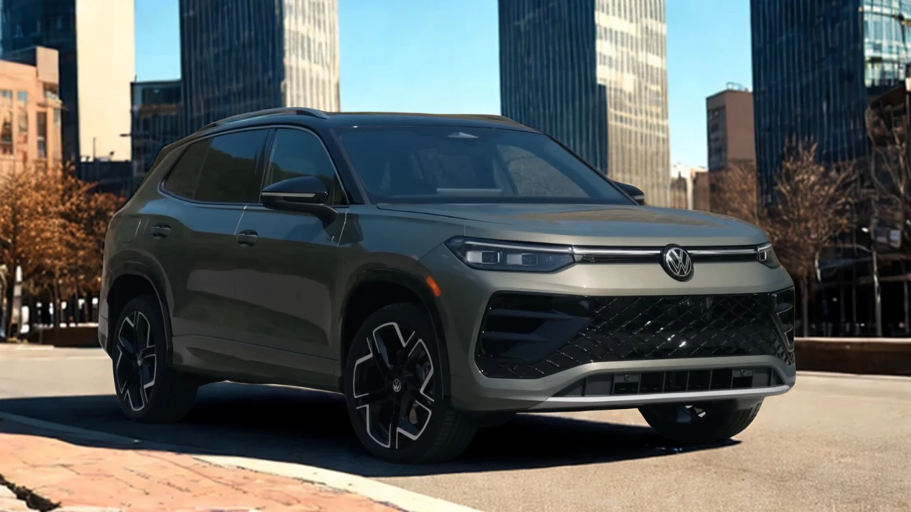 Three-quarter front view of 2025 Volkswagen Tiguan in gray metallic showing side profile, alloy wheels, and modern SUV proportions