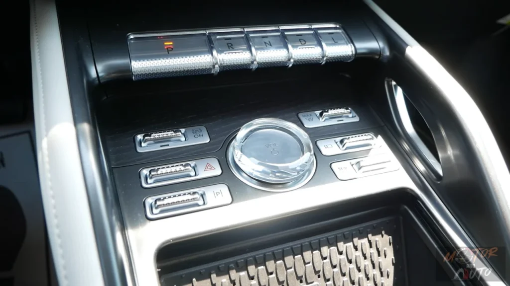 Detailed view of 2025 Lincoln Nautilus center console showing crystal volume knob, premium control buttons, and luxury material finishes
