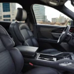 Center console area of 2025 Lincoln Nautilus showing luxury interior materials, premium finishes, and sophisticated design details from a side angle