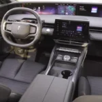 Complete dashboard view of 2025 Lincoln Nautilus showing the full 48-inch curved display spanning the width of the cabin, steering wheel, and luxury interior appointments
