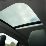 Interior view looking up at the panoramic sunroof of 2025 Lincoln Nautilus showing the large glass opening and interior headliner details