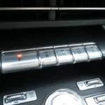 Piano key style transmission shifter in 2025 Lincoln Nautilus showing P, R, N, D, L buttons with premium metallic finish and surrounding control buttons
