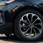 Close-up detail of 2025 Lincoln Nautilus alloy wheel showing multi-spoke design, Michelin tire branding, and side body styling with functional air curtain vents