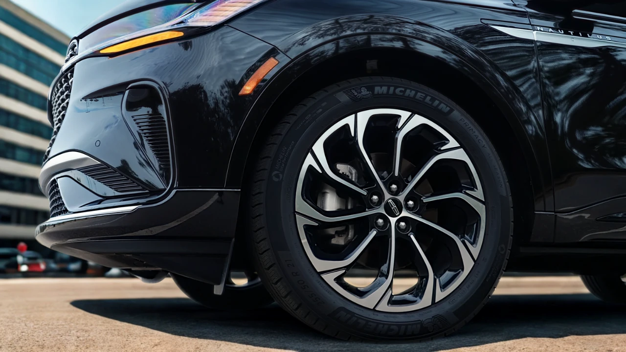 Close-up detail of 2025 Lincoln Nautilus alloy wheel showing multi-spoke design, Michelin tire branding, and side body styling with functional air curtain vents