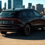 Rear three-quarter angle view of 2025 Lincoln Nautilus in urban setting showing overall vehicle design, LED tail light bar, wheel configuration, and city skyline background