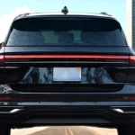 Rear view of 2025 Lincoln Nautilus showing continuous LED tail light bar across the width, Lincoln lettering, license plate area, and lower bumper design