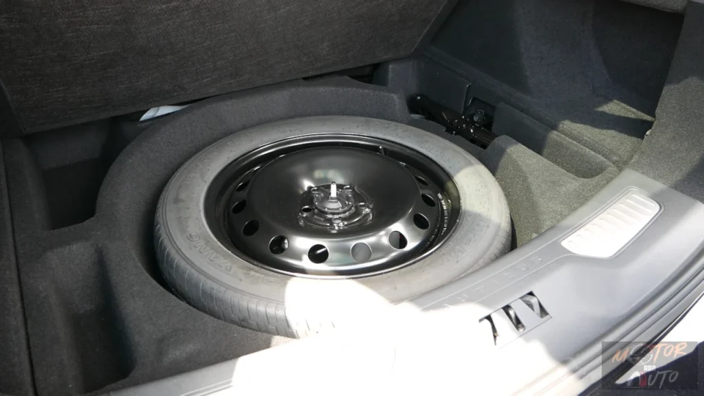 Under-floor cargo area of 2025 Lincoln Nautilus showing full-size spare tire storage and additional compartment space for tools and accessories