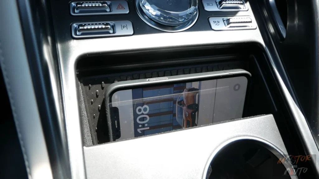 Wireless charging pad in 2025 Lincoln Nautilus center console with smartphone placed on the charging surface, showing convenient device storage solution