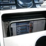 Wireless charging pad in 2025 Lincoln Nautilus center console with smartphone placed on the charging surface, showing convenient device storage solution