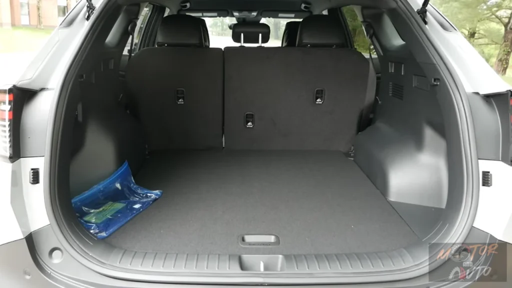 Cargo area of 2026 Kia Sportage with rear seats up showing 39.6 cubic feet of storage space, low load floor, and cargo area features