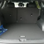 Cargo area of 2026 Kia Sportage with rear seats up showing 39.6 cubic feet of storage space, low load floor, and cargo area features