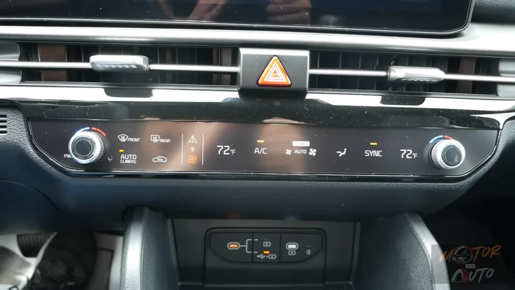Climate control panel of 2026 Kia Sportage showing dual-zone automatic system with temperature controls, AC, auto climate, sync function, and defrost options