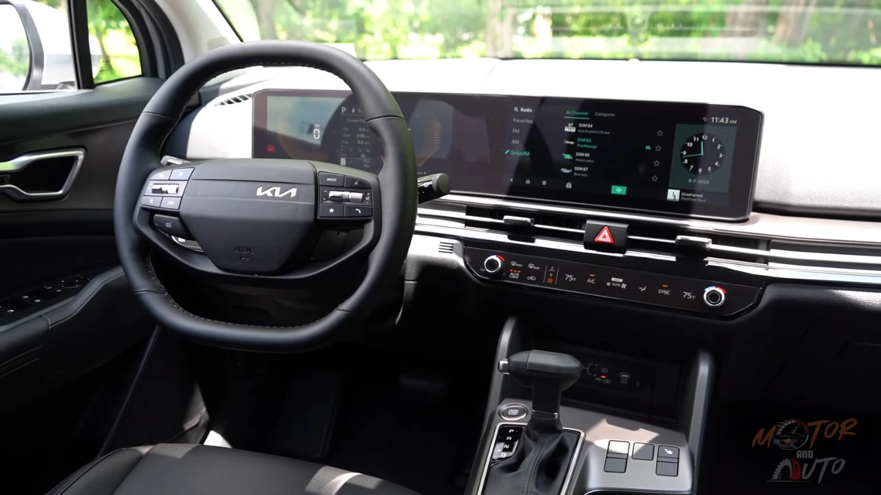 Dashboard view of 2026 Kia Sportage displaying dual 12.3-inch screens, updated infotainment interface, climate control panel, and new steering wheel design