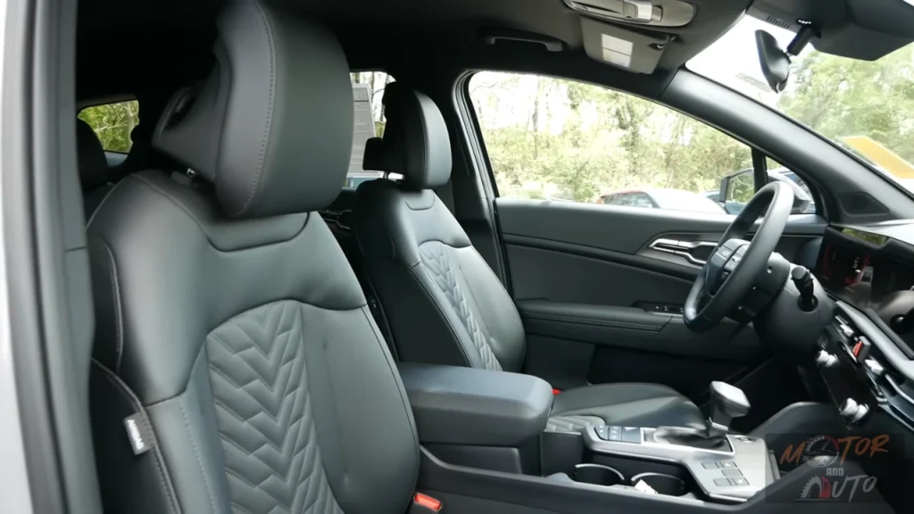 Side profile view of 2026 Kia Sportage front seats showing SynTex leatherette upholstery with quilted chevron pattern, adjustable headrests, and premium interior finishing
