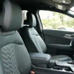 Side profile view of 2026 Kia Sportage front seats showing SynTex leatherette upholstery with quilted chevron pattern, adjustable headrests, and premium interior finishing
