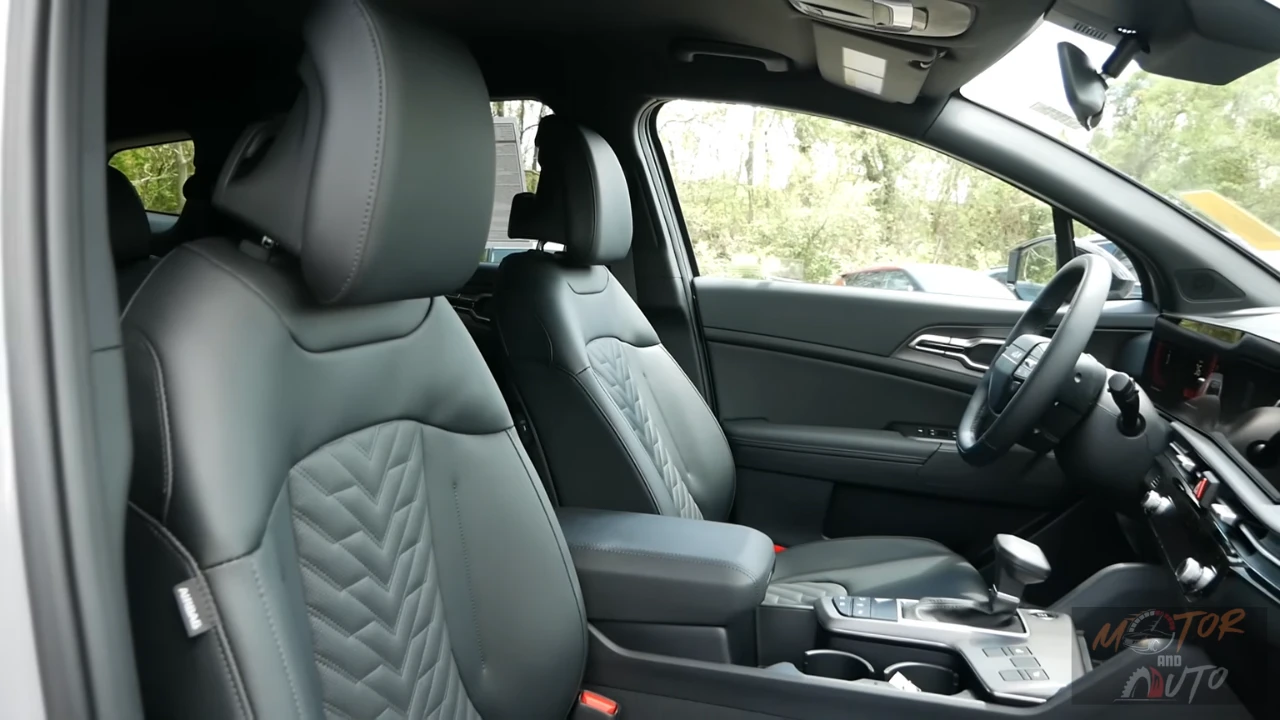 Side profile view of 2026 Kia Sportage front seats showing SynTex leatherette upholstery with quilted chevron pattern, adjustable headrests, and premium interior finishing