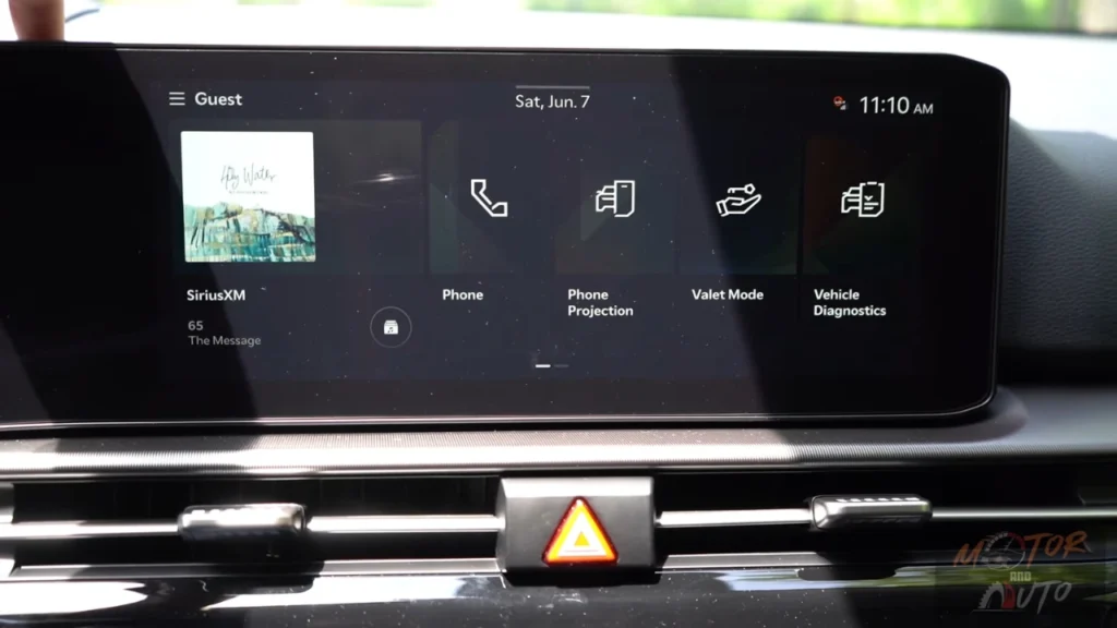 Infotainment home screen of 2026 Kia Sportage showing widget layout with SiriusXM, phone, phone projection, valet mode, and vehicle diagnostics options