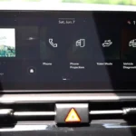 Infotainment home screen of 2026 Kia Sportage showing widget layout with SiriusXM, phone, phone projection, valet mode, and vehicle diagnostics options