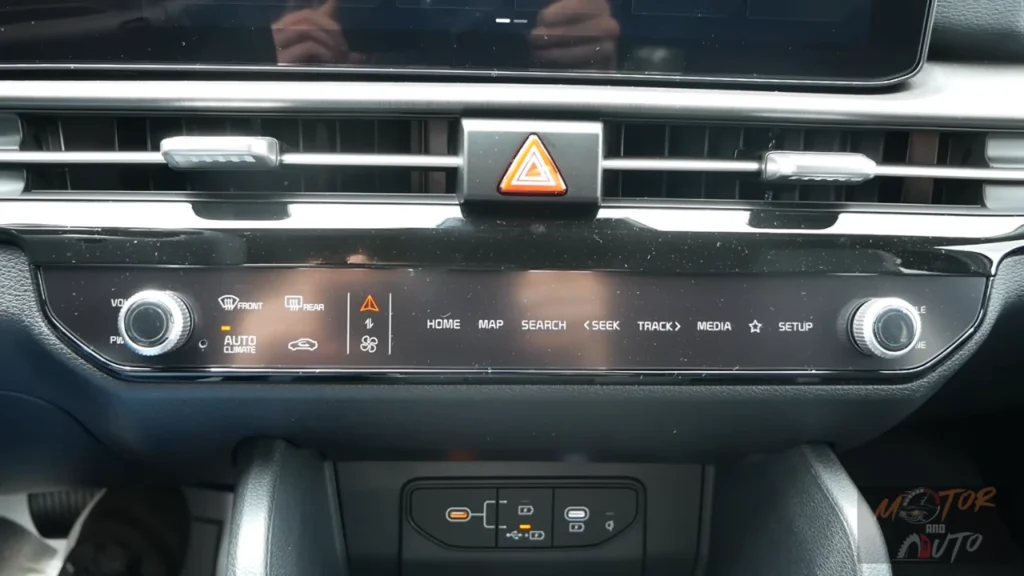 Media control interface of 2026 Kia Sportage infotainment system showing home, map, search, seek, track, media, and setup buttons with dual-function control panel