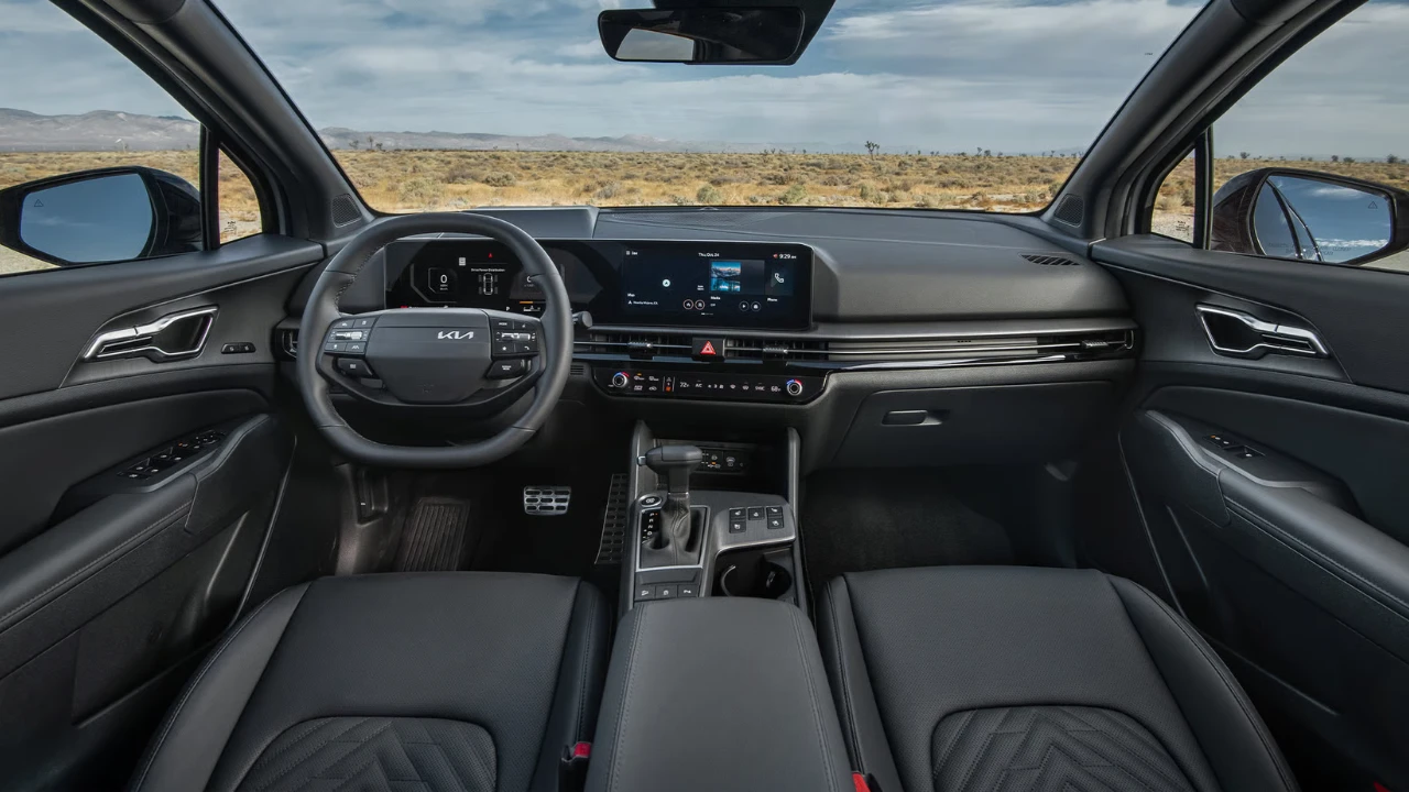 Wide-angle interior view of 2026 Kia Sportage showing complete dashboard, dual 12.3-inch displays, center console, gear shifter, and premium interior appointments
