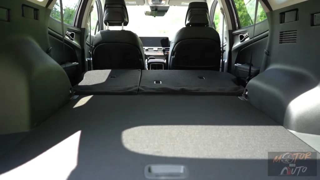 Interior cargo view of 2026 Kia Sportage with rear seats folded down showing maximum 74.1 cubic feet of storage space and flat loading floor