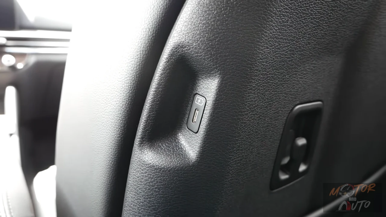 Close-up view of USB-C charging port integrated into front seatback of 2026 Kia Sportage for rear passenger device charging convenience