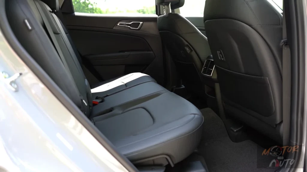 Rear seat passenger view in 2026 Kia Sportage showing spacious legroom, comfortable seating position, and premium interior appointments for second-row occupants